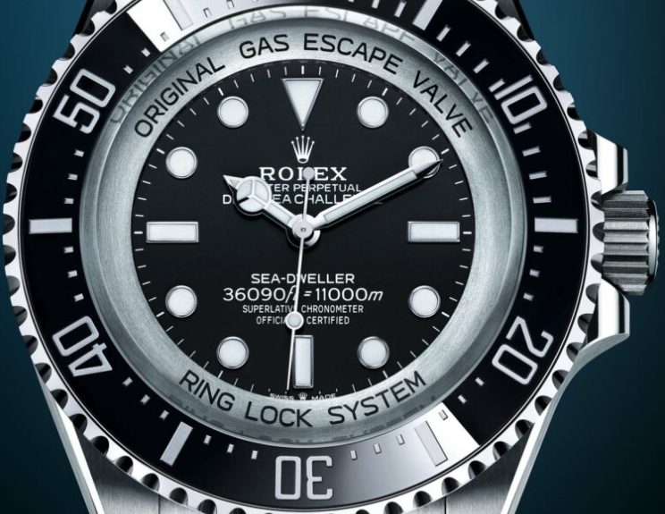 Close up of the black dial luminous markers and graduated bezel on a Deepsea Challenge style watch