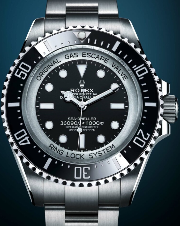 Close up of the black dial luminous markers and graduated bezel on a Deepsea Challenge style watch