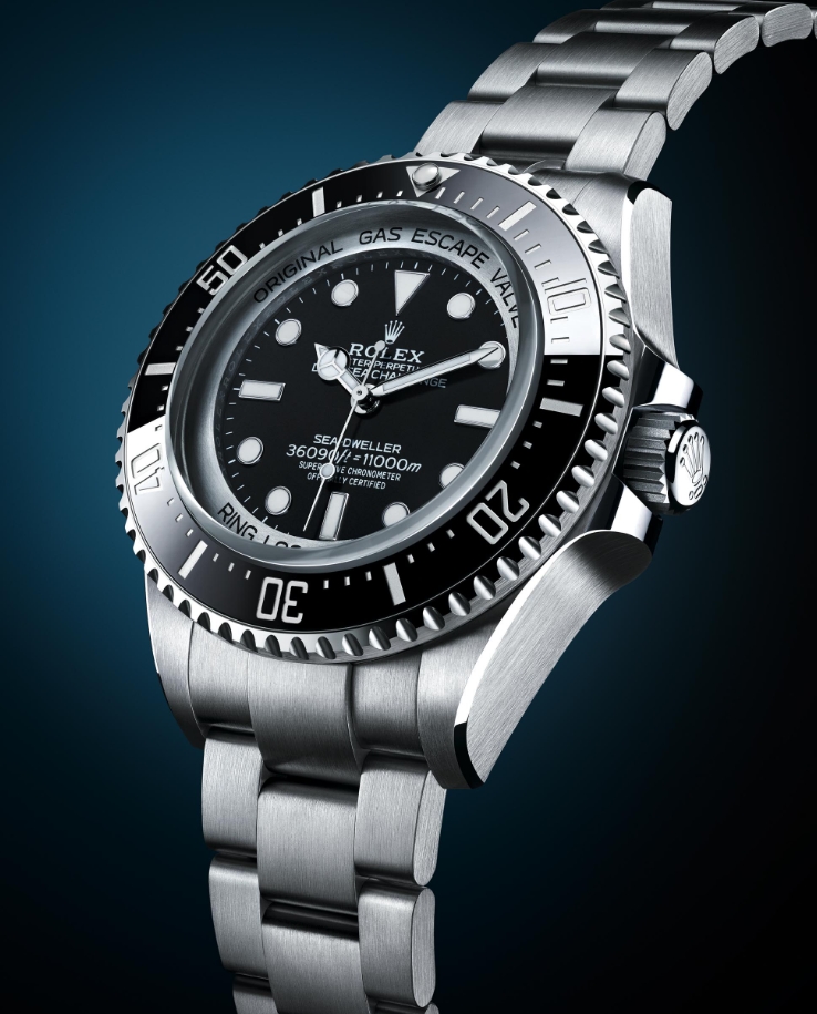 Full view of a Deepsea Challenge style watch with black dial and metal bracelet
